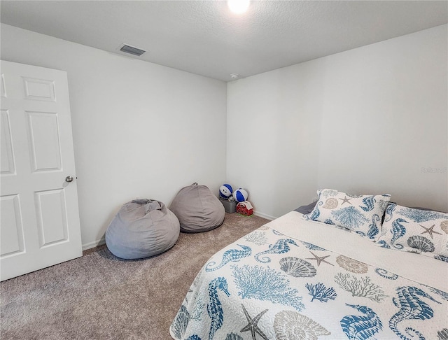 bedroom featuring carpet flooring and a textured ceiling