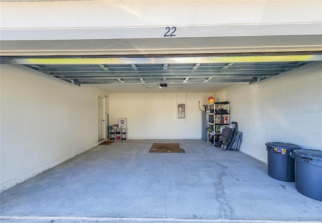 garage with electric panel and a garage door opener