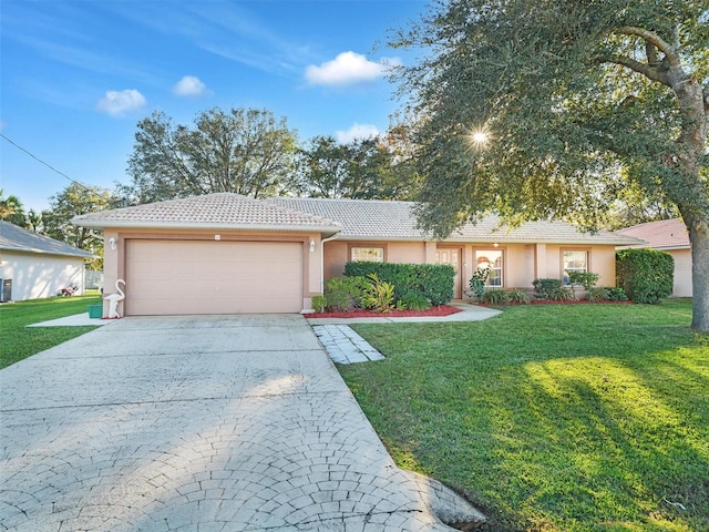 ranch-style house with a garage and a front yard