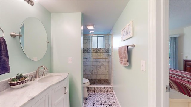 bathroom featuring toilet, tile patterned flooring, vanity, and walk in shower