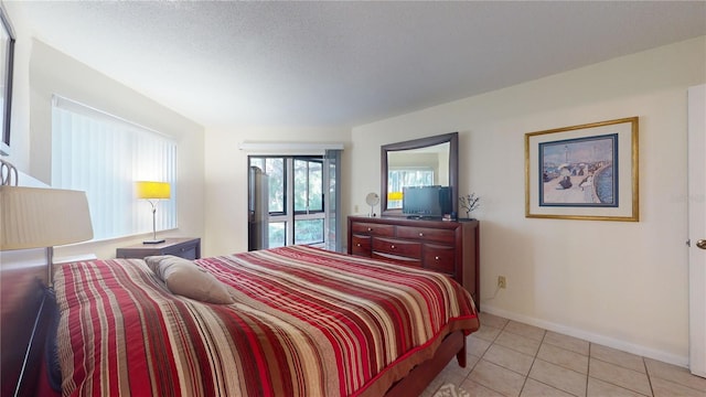 tiled bedroom featuring access to exterior and a textured ceiling