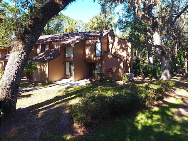 rear view of house featuring a lawn