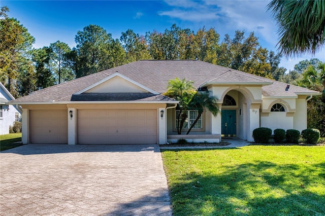 single story home featuring a garage and a front yard