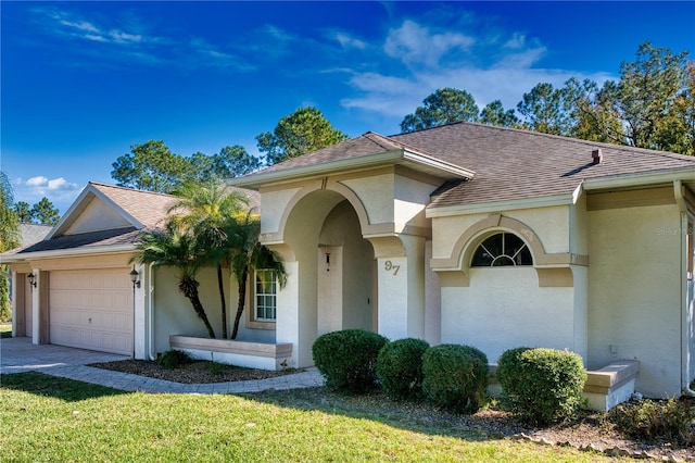 view of front of home with a garage and a front lawn