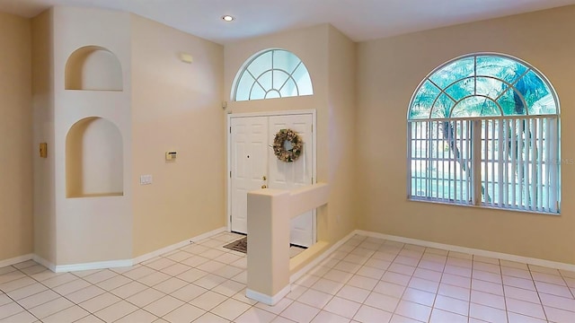 foyer featuring plenty of natural light and light tile patterned floors