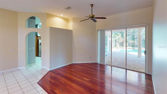 empty room featuring ceiling fan and light hardwood / wood-style floors