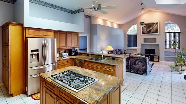 kitchen featuring stainless steel appliances, high vaulted ceiling, ceiling fan, and sink