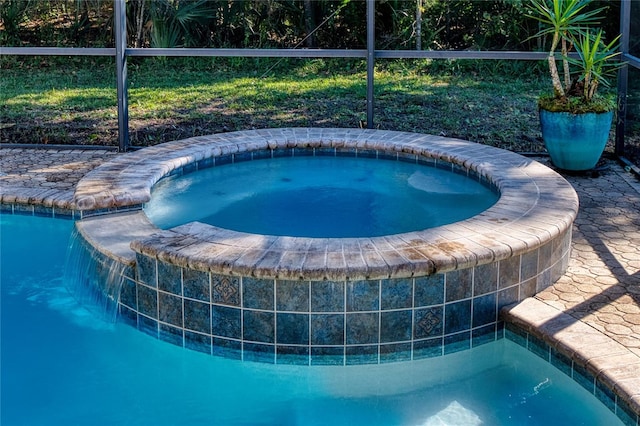 view of pool with an in ground hot tub