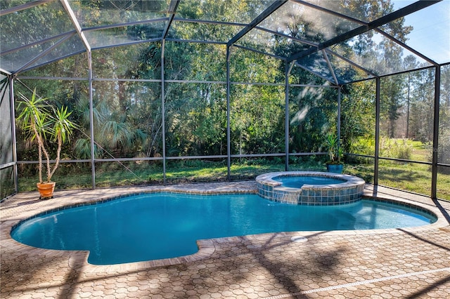 view of swimming pool featuring glass enclosure, an in ground hot tub, and a patio area