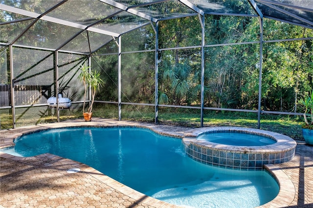 view of swimming pool with an in ground hot tub and a lanai