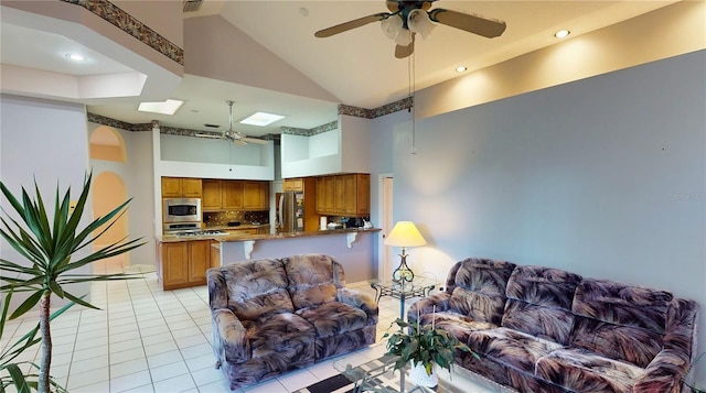 living room with light tile patterned floors and high vaulted ceiling