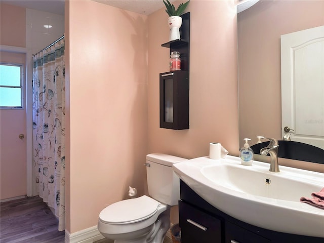 bathroom featuring hardwood / wood-style floors, vanity, toilet, and a shower with curtain