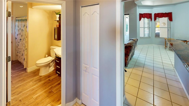 bathroom featuring toilet and hardwood / wood-style flooring