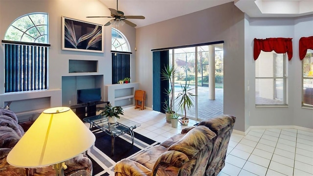 tiled living room with plenty of natural light and ceiling fan