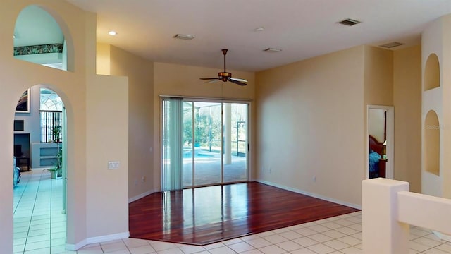 empty room featuring ceiling fan and light hardwood / wood-style floors