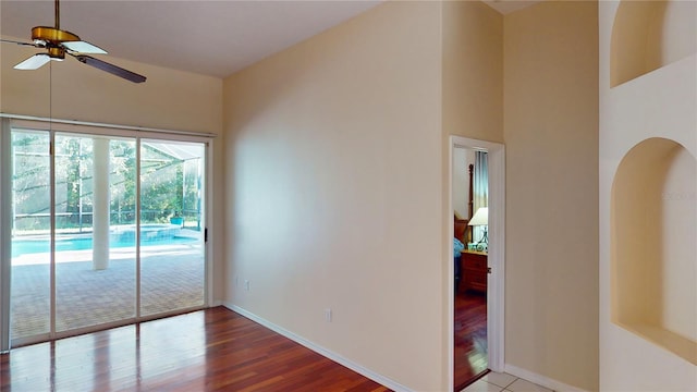 spare room with wood-type flooring and ceiling fan