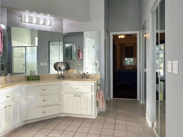 bathroom with tile patterned floors, vanity, and a shower with shower door