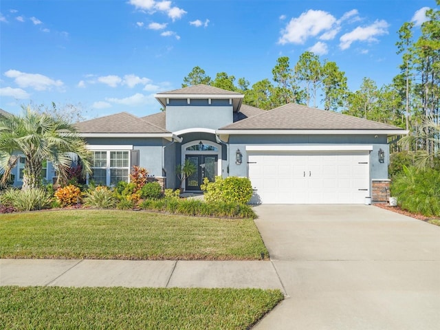 view of front of property featuring a front lawn and a garage