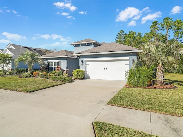 view of front facade with a front yard and a garage