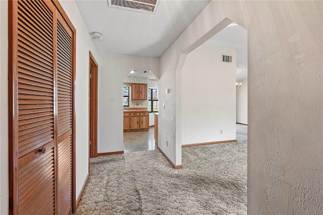 hallway featuring light carpet