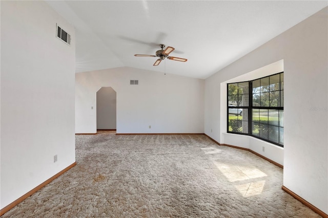 carpeted spare room with vaulted ceiling and ceiling fan