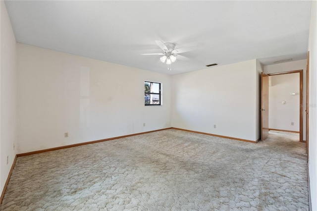 empty room with ceiling fan and light colored carpet