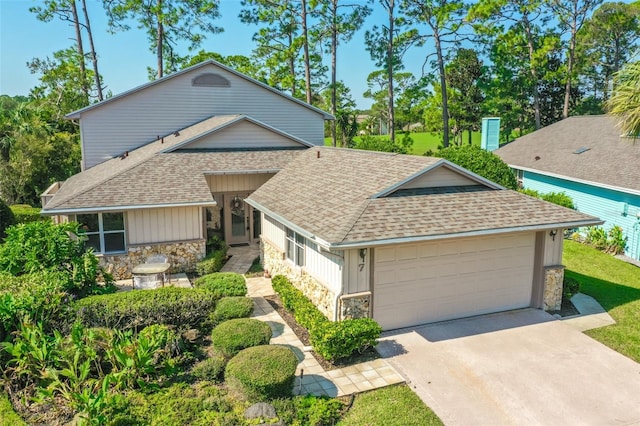 7 Jasmine Run, Ormond Beach, FL 32174 - view of front of property featuring stone siding, a shingled roof, a garage, and concrete driveway