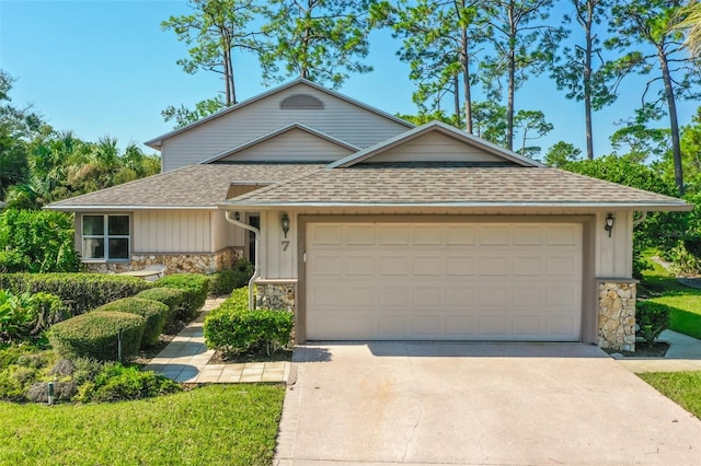 7 Jasmine Run, Ormond Beach, FL 32174 - view of front of home featuring stone siding, an attached garage, and driveway