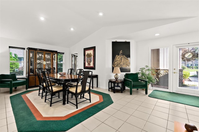 tiled dining space with vaulted ceiling