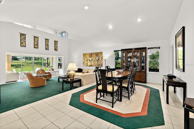 dining area with lofted ceiling and light tile patterned flooring