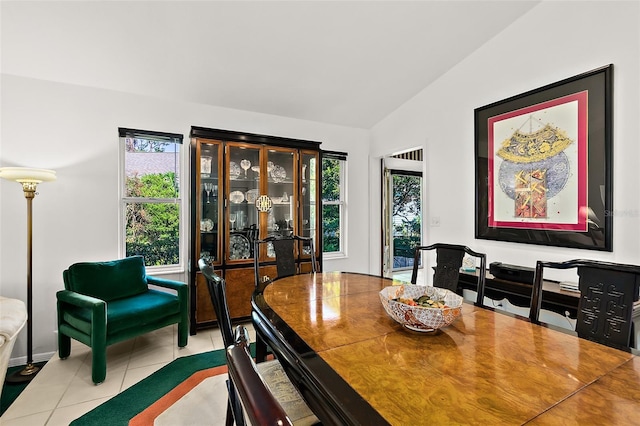 tiled dining room with plenty of natural light and vaulted ceiling