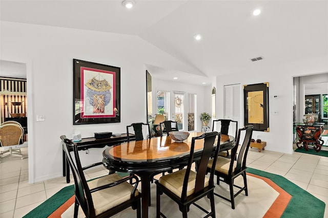 tiled dining area featuring lofted ceiling