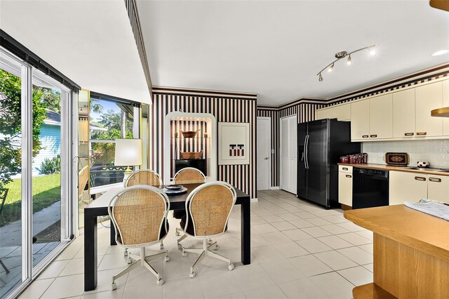 kitchen with black appliances, white cabinetry, backsplash, and light tile patterned floors