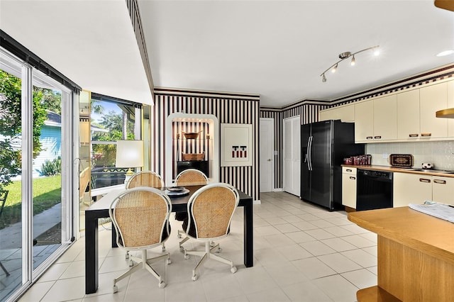 7 Jasmine Run, Ormond Beach, FL 32174 - kitchen featuring black appliances, decorative backsplash, light tile patterned floors, white cabinetry, and cream cabinets
