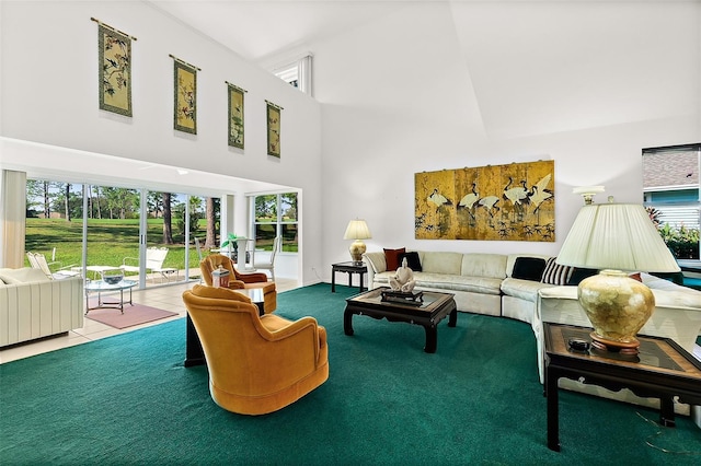 living room with plenty of natural light, carpet floors, and a high ceiling