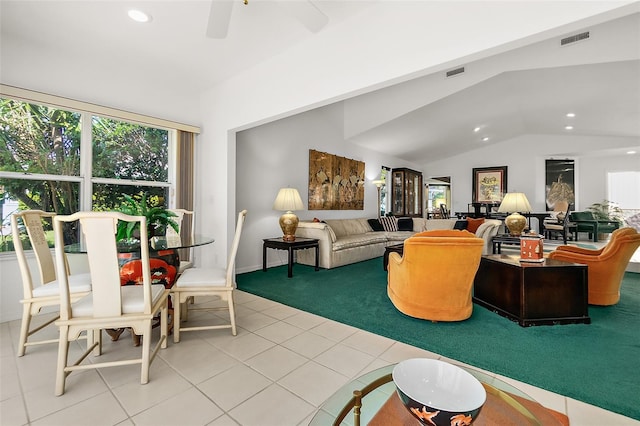 living room featuring ceiling fan, light tile patterned flooring, and lofted ceiling