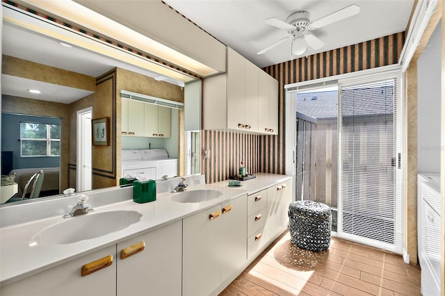 bathroom featuring vanity, hardwood / wood-style flooring, washer and clothes dryer, and ceiling fan