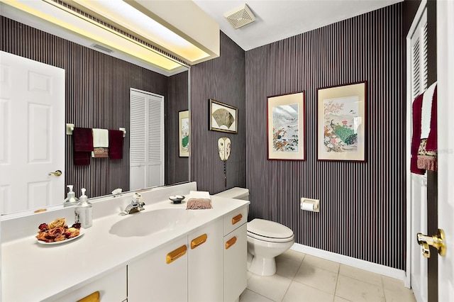 bathroom featuring tile patterned floors, vanity, and toilet