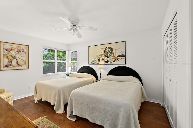 bedroom featuring ceiling fan, a closet, and dark hardwood / wood-style floors