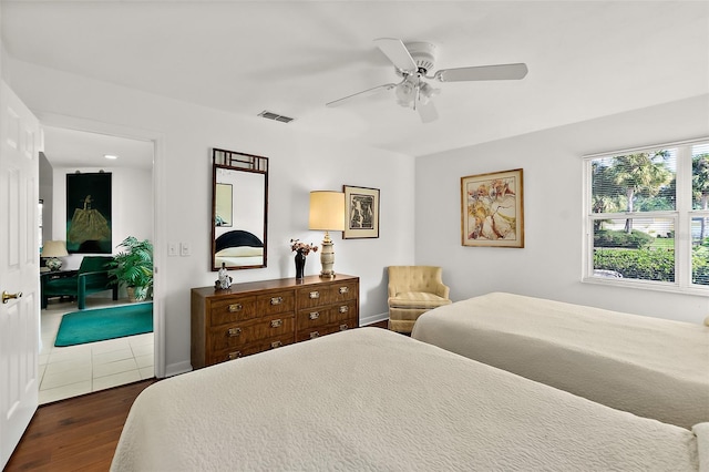 bedroom with ceiling fan and dark hardwood / wood-style floors