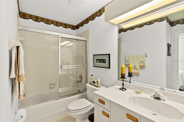 full bathroom featuring tile patterned floors, vanity, toilet, and bath / shower combo with glass door