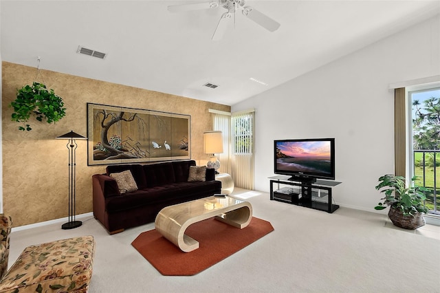 living room featuring ceiling fan, light colored carpet, and vaulted ceiling