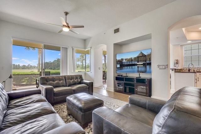 living room with ceiling fan and light hardwood / wood-style floors