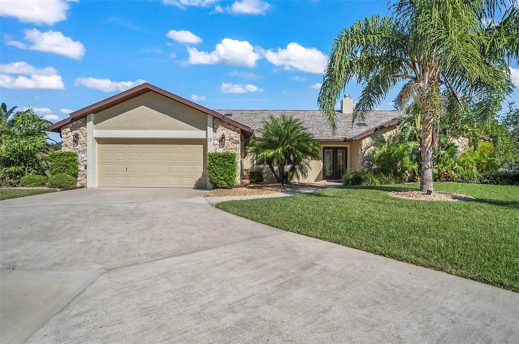 ranch-style home featuring a garage and a front lawn