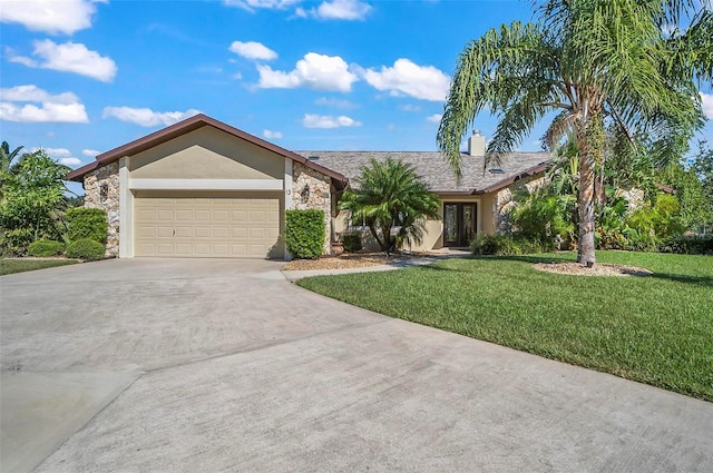 ranch-style home featuring a garage and a front lawn