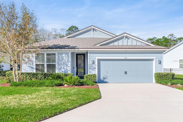 ranch-style house featuring a front yard and a garage