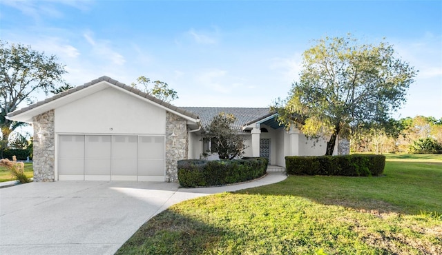 ranch-style home featuring a garage and a front lawn