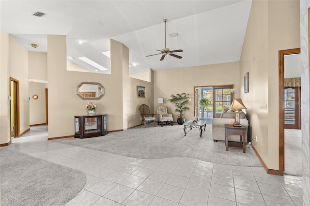 interior space featuring ceiling fan, light tile patterned floors, and high vaulted ceiling