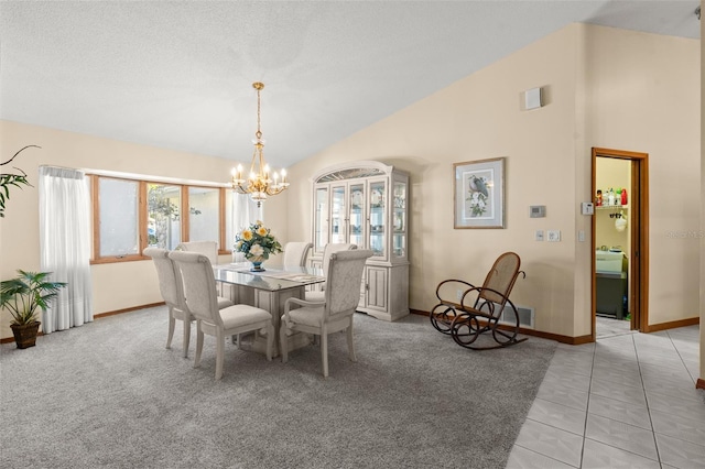 dining room featuring lofted ceiling, a textured ceiling, light tile patterned floors, and a chandelier