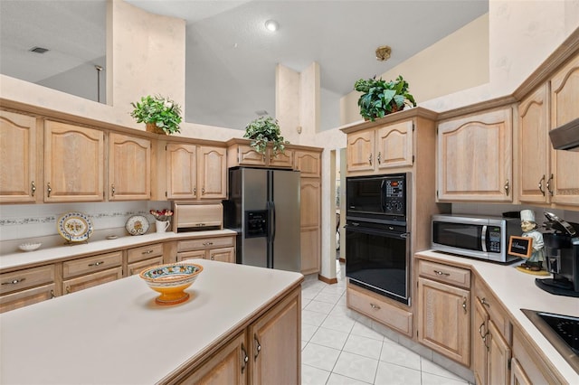 kitchen featuring black appliances, light brown cabinets, light tile patterned floors, and high vaulted ceiling